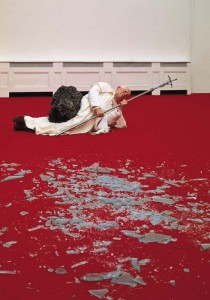 Maurizio Cattelan, La Nona Ora (The Ninth Hour), 1999; wax, clothing, polyester resin with metallic powder, volcanic rock, carpet, glass, dimensions variable; photo via Christie's